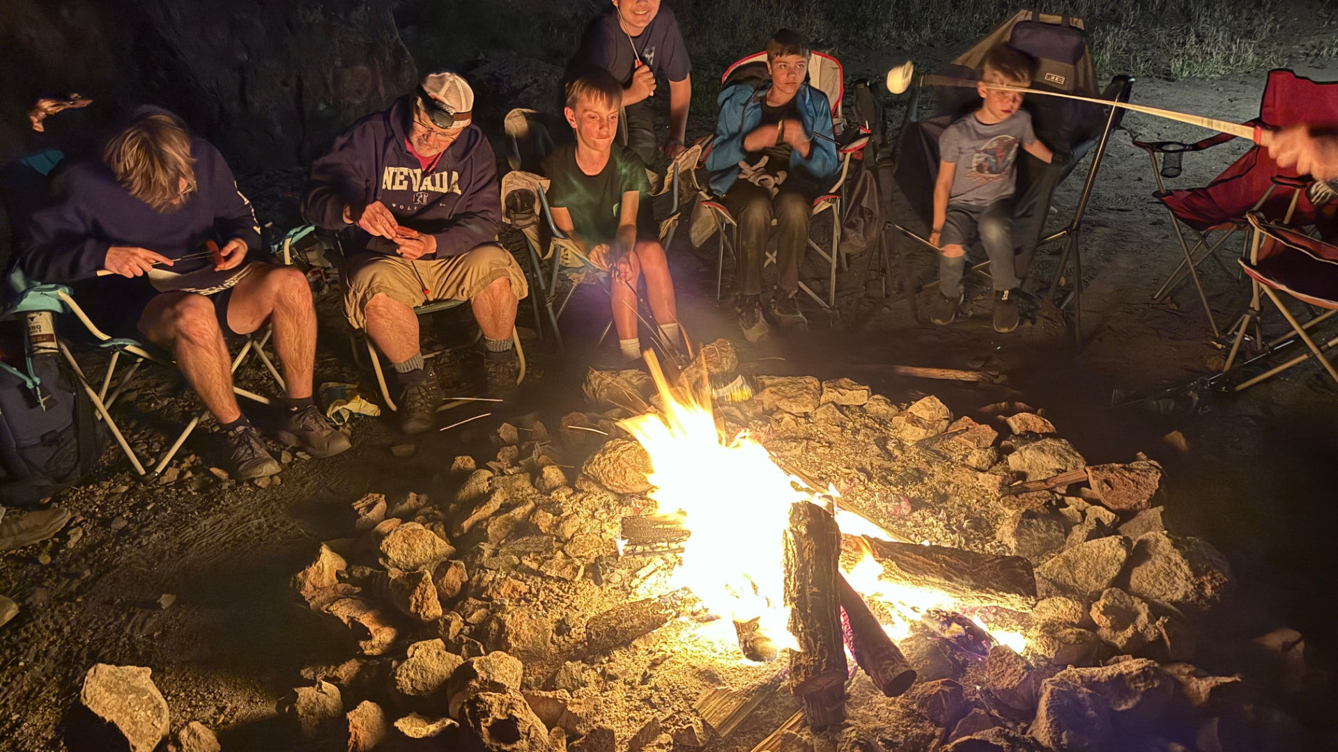 Youth and leaders around a campfire