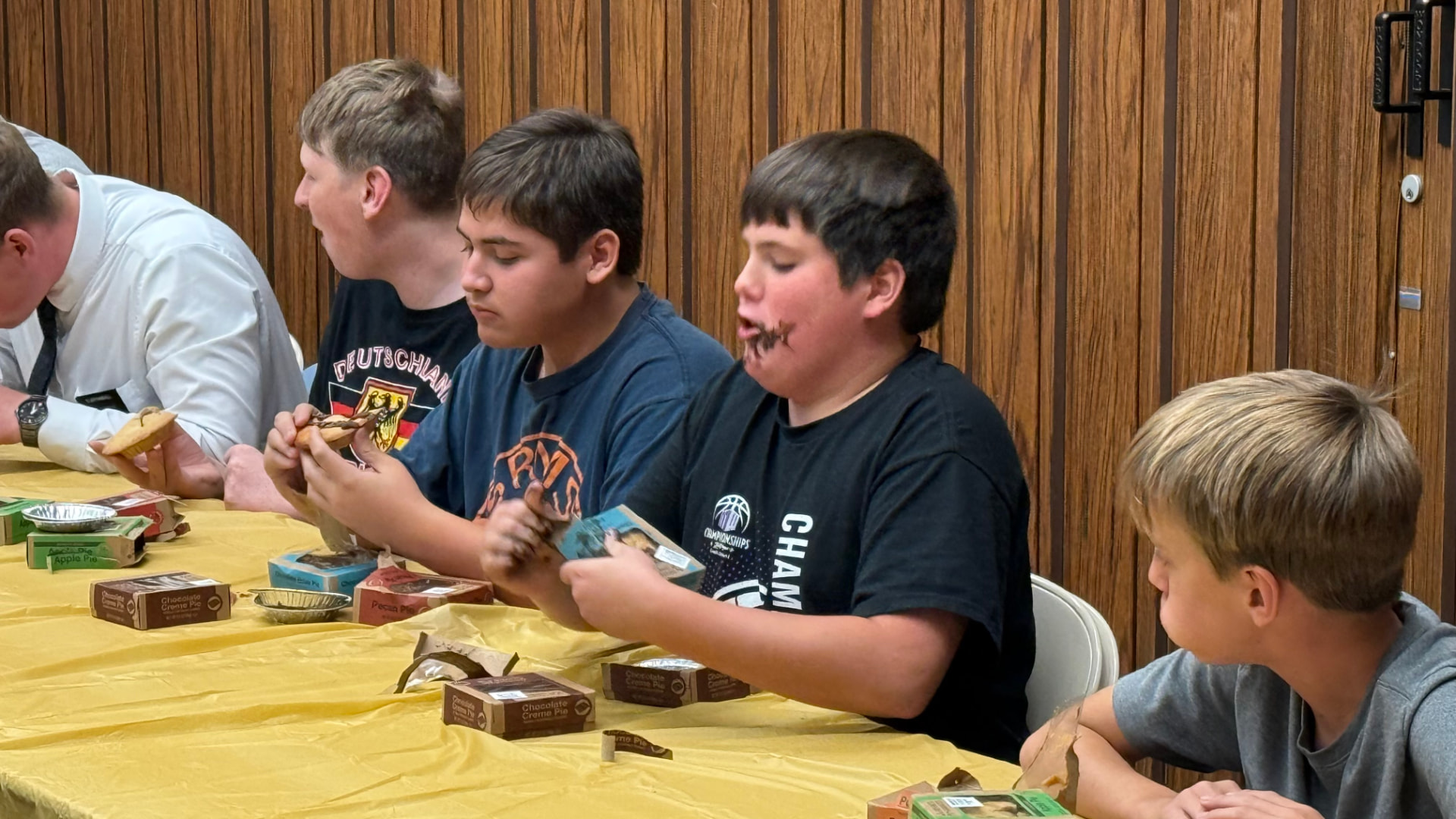 Young men enjoying a pie-eating activity